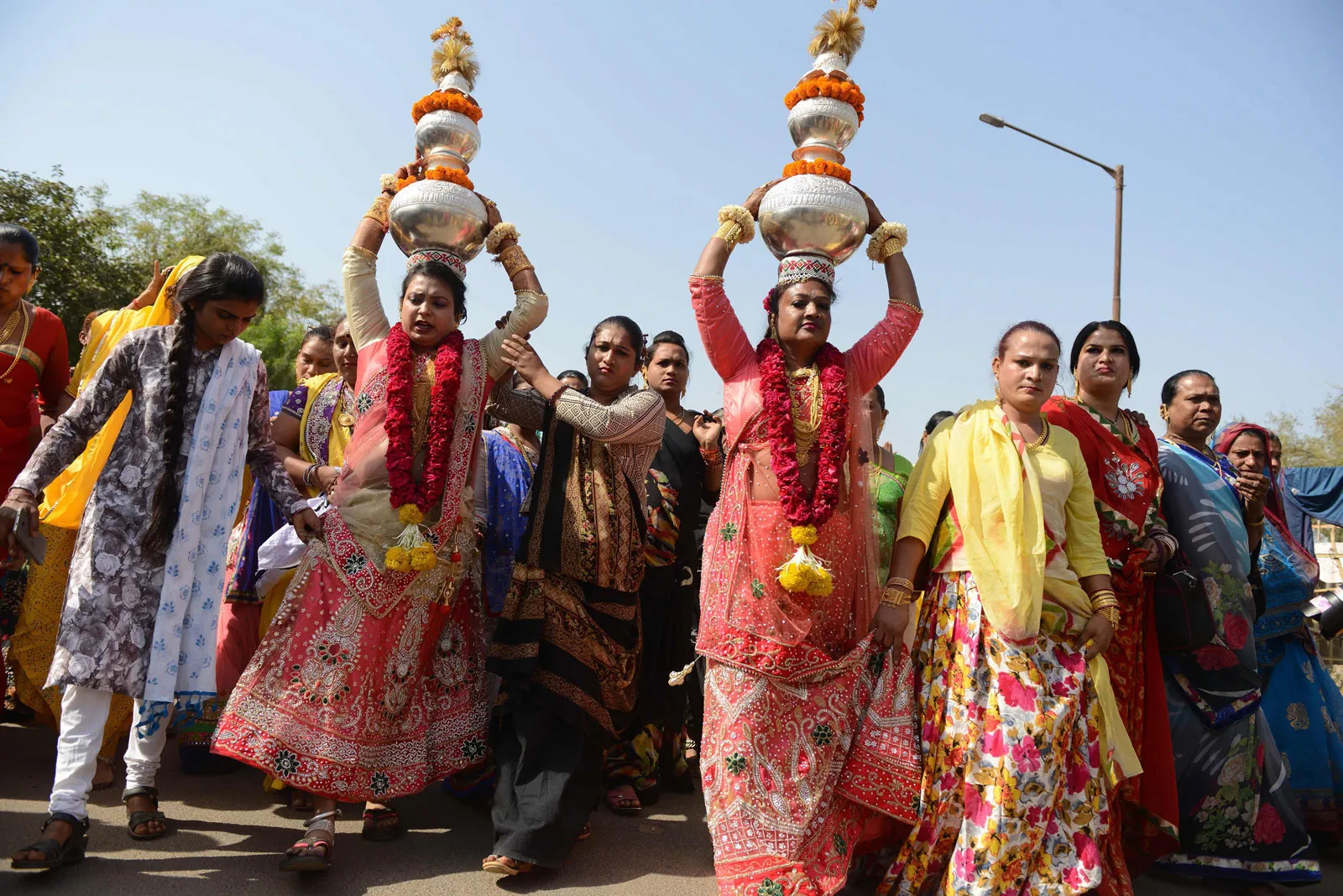 A photo of colourfully-dressed Hirja people participating in a Hindu religious procession.