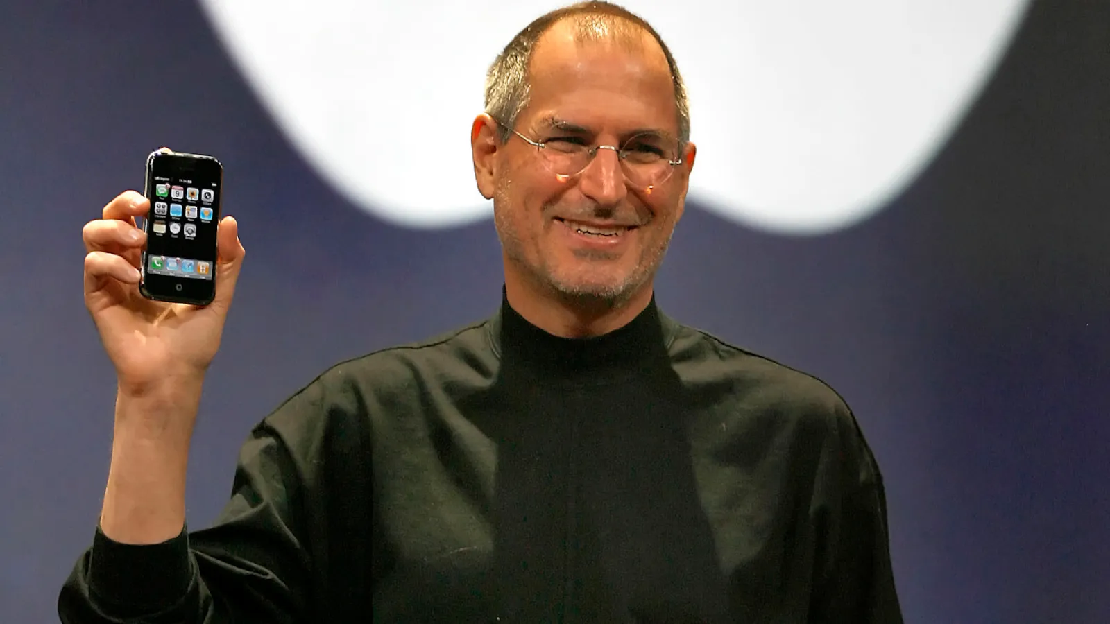 Steve Jobs holding up the original iPhone during his 2007 keynote.