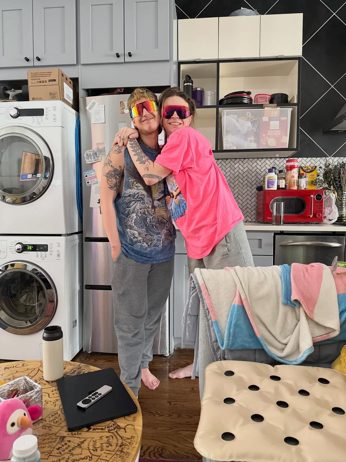 Grace and a friend embracing at home.