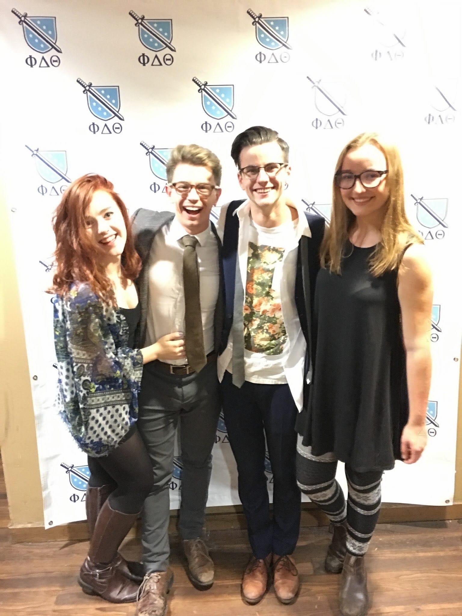 An archival photograph of four people at a student event.